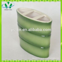 green hotel toothbrush holder with bamboo design